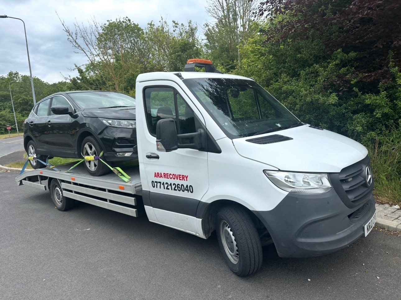 ARA Recovery flatbed truck carrying an SUV