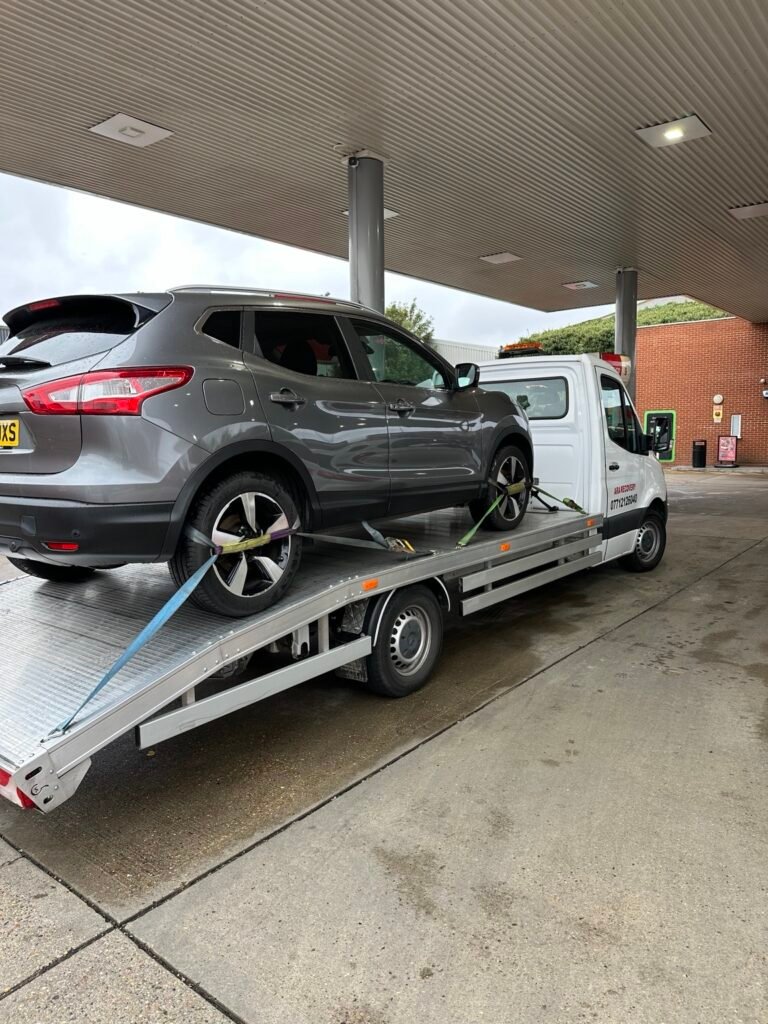 Grey SUV loaded on an ARA Recovery truck
