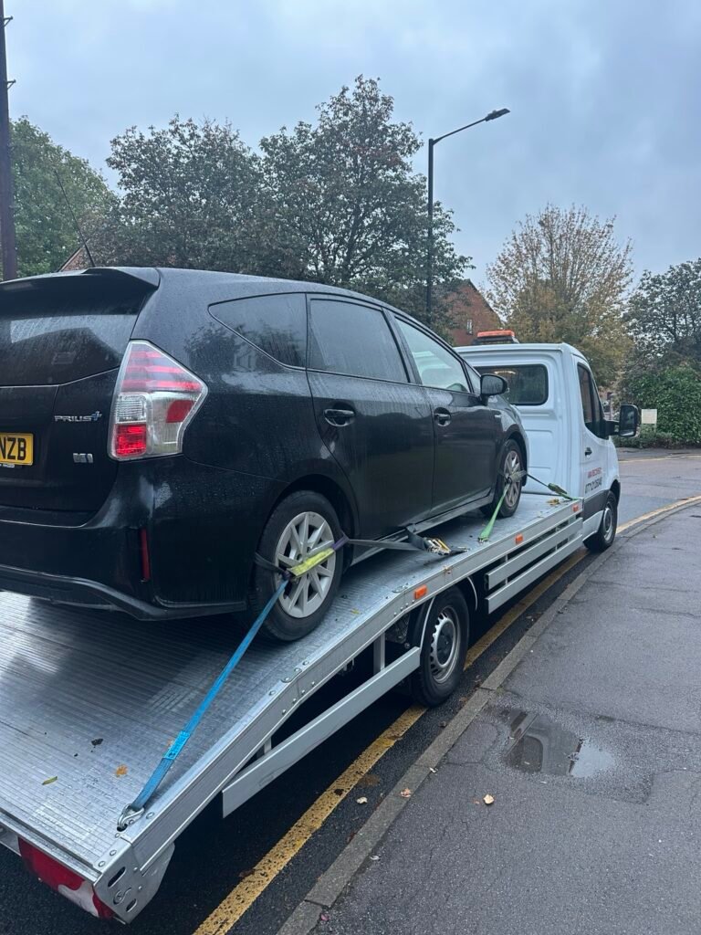 Rear view of a Toyota Prius secured for transport by ARA Recovery