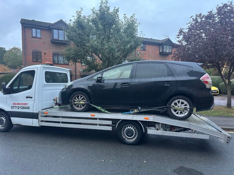 Black Toyota Prius secured on the ARA Recovery flatbed truck