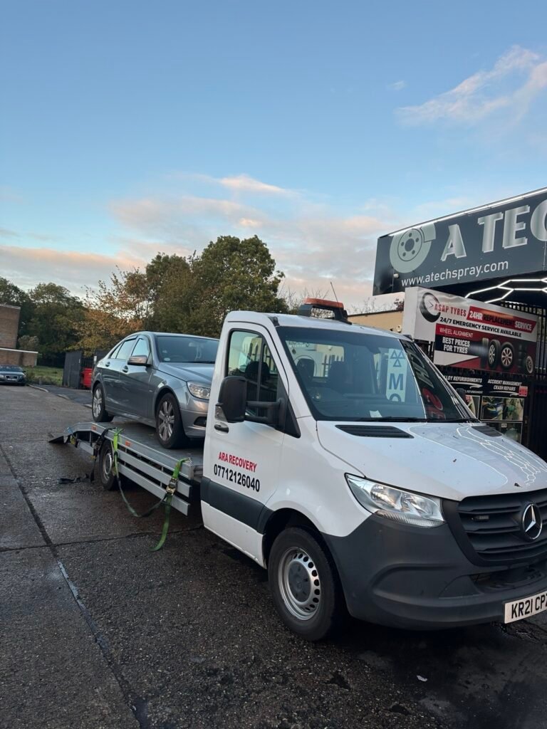ARA Recovery truck transporting a silver Mercedes to a garage