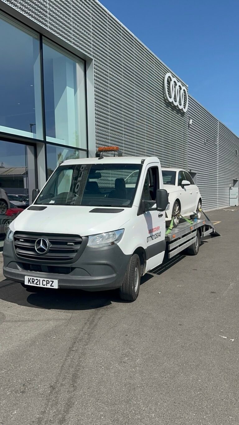 ARA Recovery truck collecting a white SUV outside an Audi dealership