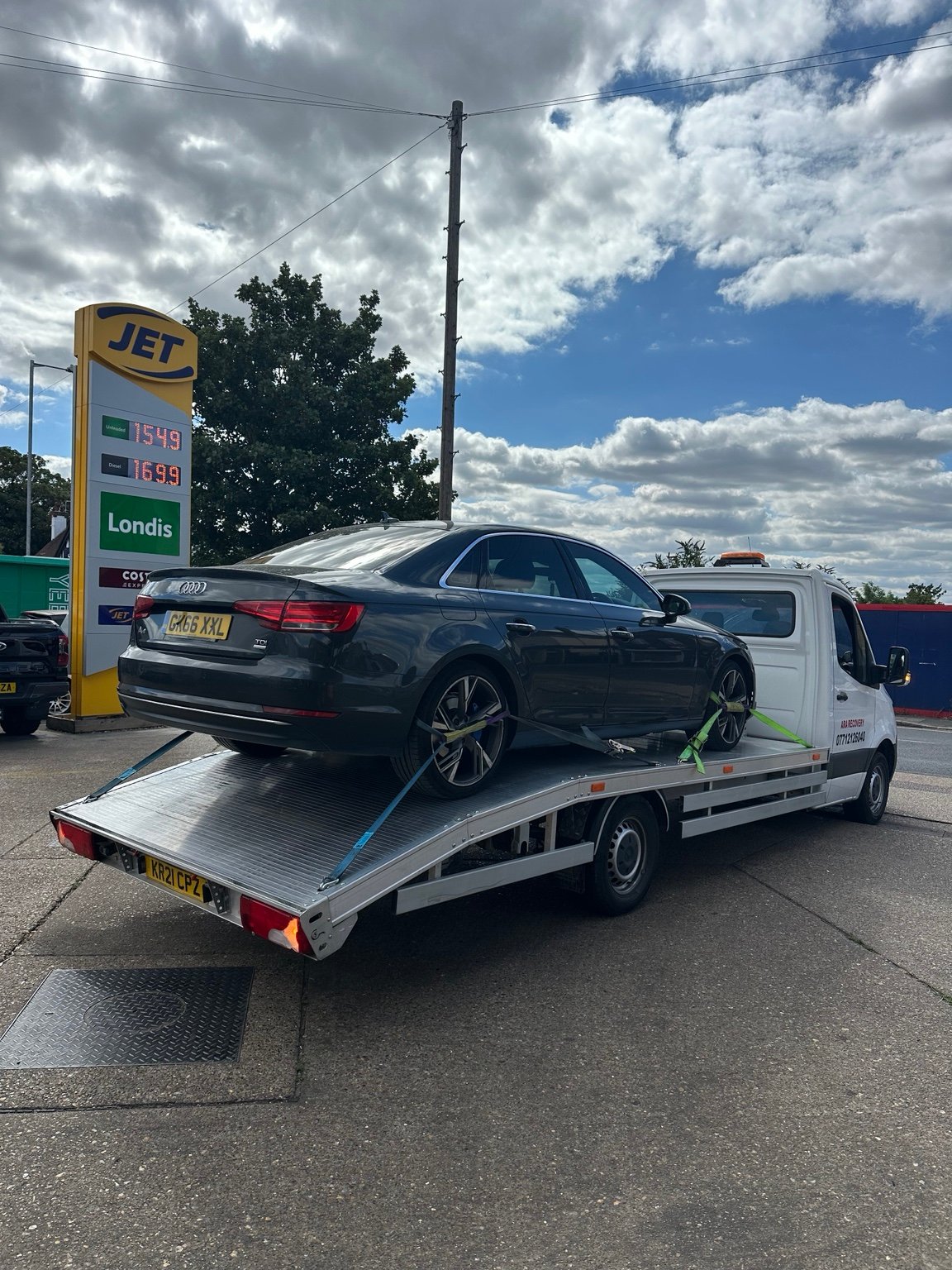 Black saloon car loaded on an ARA Recovery flatbed