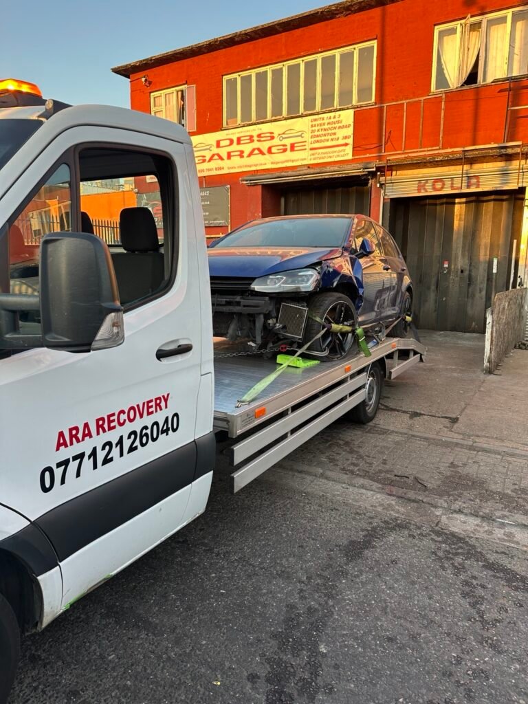 Accident-damaged car collected by ARA Recovery outside a garage